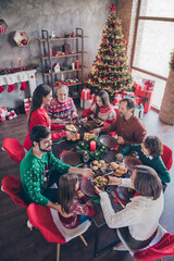 Vertical photo friendly family having festive christmas dinner on winter holidays indoors apartment