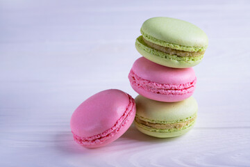 Pink green macaroons on a white background. Beautiful macaroons. Delicious background