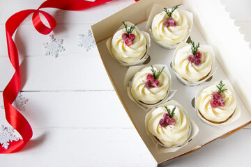 Homemade christmas cupcakes with cranberries.Sugared cranberry  cupcakes in delyvery box. Christmas sweet gift background