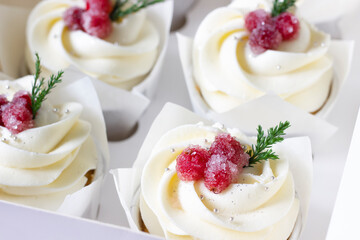 Homemade christmas cupcakes with cranberries.Sugared cranberry  cupcakes in delyvery box. Christmas sweet gift background