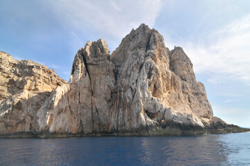 Naklejka premium Limestone cliffs of the Capo Caccia cape at the Gulf of Alghero, Sardinia, Italy 