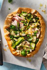 Green pizza with spinach, zucchini, asparagus and peas.
