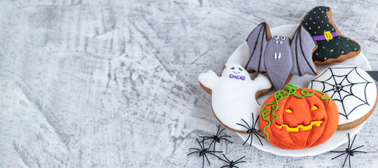 banner with delicious halloween cookies on white textured concrete.