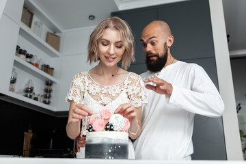 Loving beautiful couple in the kitchen with cake. Anniversary