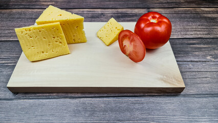 The Natural cheese and fresh red tomato. Natural tomato and cheese.