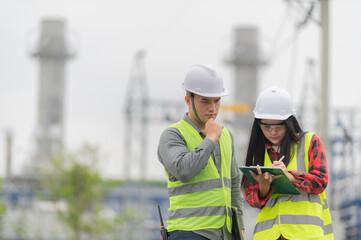 Two engineer working at power plant,Work together happily,Help each other analyze the problem,Consult about development guidelines