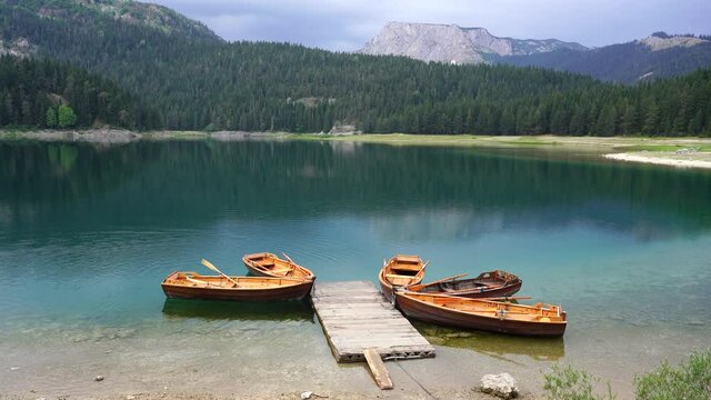 View of the Black Lake or Crno jezero , northern Montenegro. Tourist boats near wooden pier on Black lake in Durmitor national park near Zabljak, Europe