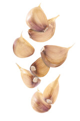 falling unpeeled cloves garlic isolated on white background.