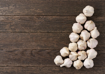 Organic garlic on a wooden table, top view.