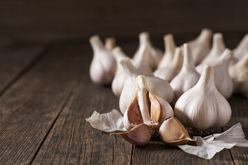 garlic cloves and bulbs on a vintage wooden table. Copy space for text.