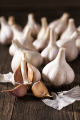 Garlic cloves and bulbs on a vintage wooden table.