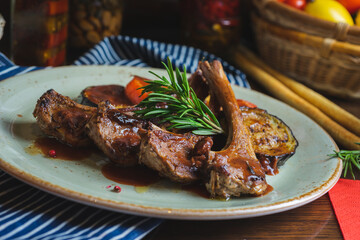 Fried ribs with a glass of red wine on a table in a restaurant close-up