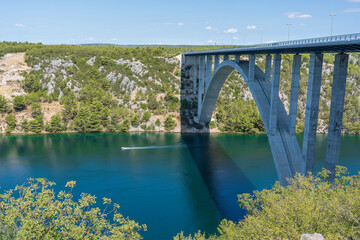 Fototapeta na wymiar View on Krka river, autostrada and arch bridge at summer in Croatia, Europe
