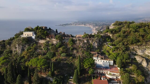 Stunning Panoramic view of the Amphitheatre of Taormina, Italy showcasing the theatre and sea of Sicily.