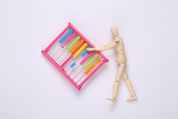 Wooden puppet holding abacus on white background. Education concept