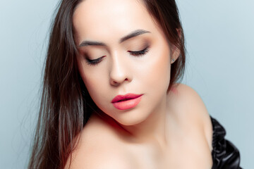 young brunette model looks down with beautiful makeup