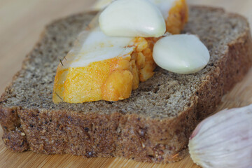  black bread with garlic and lard on the board close-up