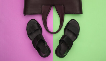 Women's leather sandals and bag on pink-green pastel background. Women's accessories. Top view. Flat lay
