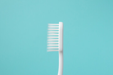 Toothbrush on blue background top view close up
