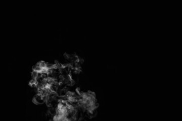 Close up of steam smoke on black background. White hot curly steam smoke isolated on black background