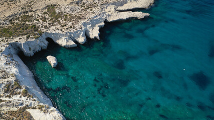Aerial drone photo of iconic lunar volcanic white chalk beach and caves of Sarakiniko, Milos island, Cyclades, Greece