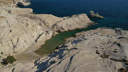 Aerial drone photo of iconic lunar volcanic white chalk beach and caves of Sarakiniko, Milos island, Cyclades, Greece