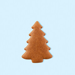 Gingerbread christmas tree on blue pastel background