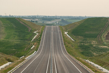 A long road with white lines leading into the distance