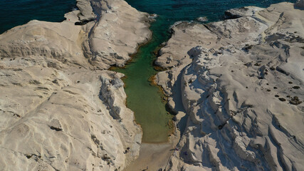 Aerial drone photo of iconic lunar volcanic white chalk beach and caves of Sarakiniko, Milos island, Cyclades, Greece