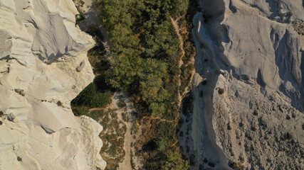 Aerial drone photo of iconic lunar volcanic white chalk beach and caves of Sarakiniko, Milos island, Cyclades, Greece