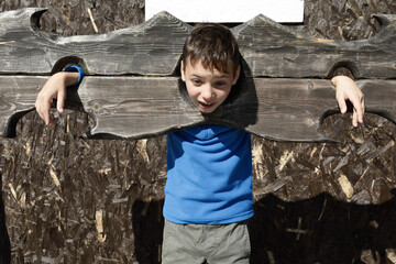Boy in wooden pillory