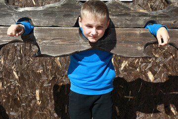 Kid in wooden pillory
