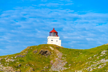 Fototapeta na wymiar The lighthouse of Runde Island on the west coast of Norway, famous for its enormous number of birds