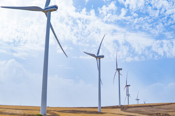 Green energy concept, eco power. Wind turbine located along the hill