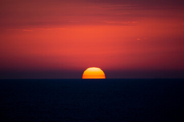 Red disk of the sun. Sea sunset.