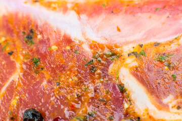 Obraz na płótnie Canvas Raw Pork meat with spices and green rosemary herb. Red meat texture background, Raw ham. Macro photo. Fat Fresh juicy steak.