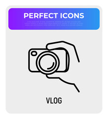 Filming vlog: camera in hand thin line icon. Modern vector illustration for video logo.