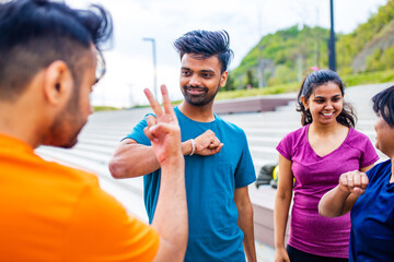 funny eastern ethnic people exercising together outdoor