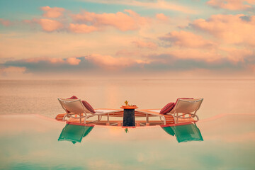 Summer love and romance table set-up for a romantic dinner meal with infinity pool reflection...