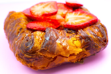 Puff pastry bun or roll. Cake with fresh strawberries. Delicious sweets temptation and desserts on...