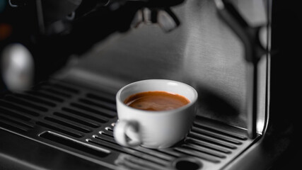 Morning coffee preparation. Coffeemaker. Close-up view of bartender preparing coffee on modern espresso machine. Professional Espresso machine making fresh coffee
