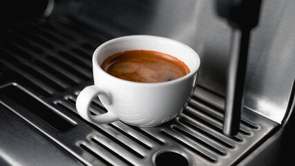 Morning coffee preparation. Coffeemaker. Close-up view of bartender preparing coffee on modern espresso machine. Professional Espresso machine making fresh coffee