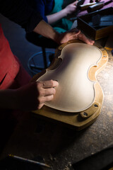 luthier while working on the creation of a violin