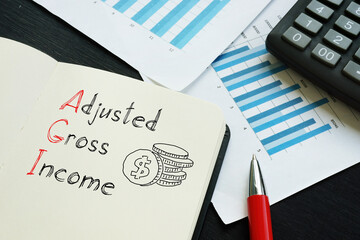 Adjusted Gross Income is shown on the business photo using the text - obrazy, fototapety, plakaty