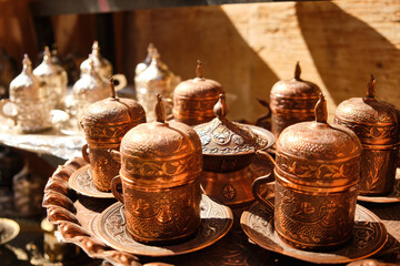 Handicraft beaded decorate arabic style tea cups. Brass colored traditional middle-eastern tea set. Turkish traditional teaware