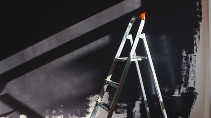 Home renovation concept - Ladder for home renovation works and painted wall
