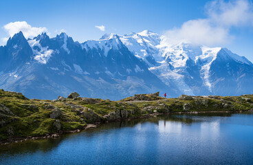 Athlete trail running at Lac De Cheserys, with the Mont Blanc in the background.