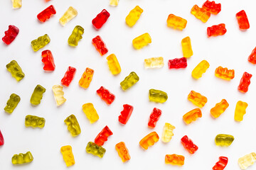 Background from multi-colored marmalade in the form of bears on a white background