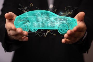 Man holding and touching holographic smart car