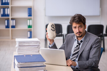 Young businessman employee and too much work in the office